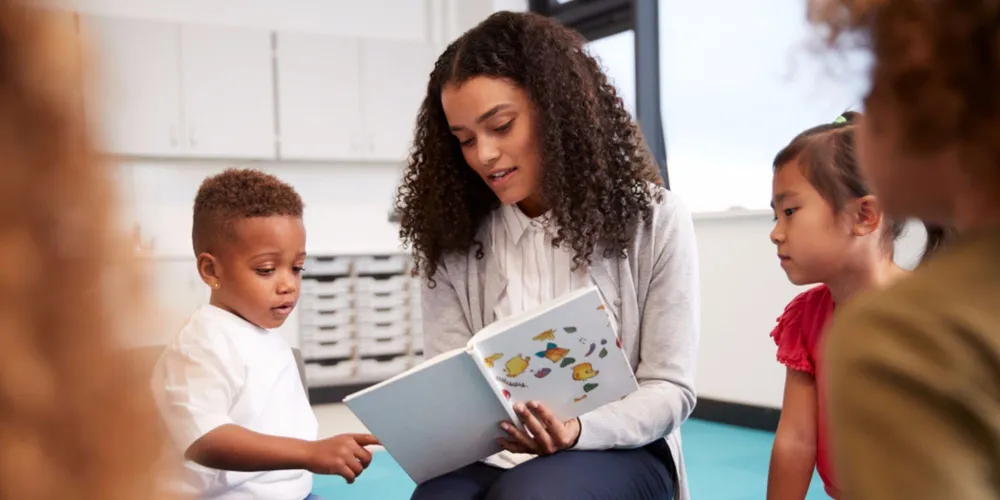 Teacher and child reading in a classroom with clean, filtered air — AQOZA